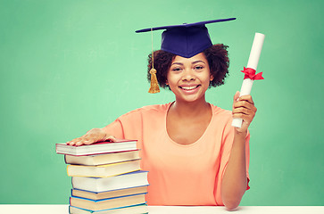 Image showing happy african bachelor girl with books and diploma