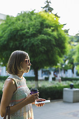 Image showing woman drinking coffee and looking at phone