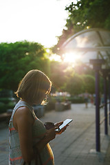 Image showing woman drinking coffee and looking at phone