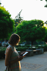 Image showing woman drinking coffee and looking at phone