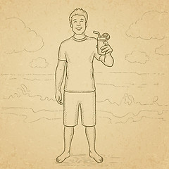 Image showing Tourist with cocktail on the beach.