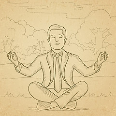 Image showing Businessman meditating in lotus pose.