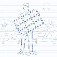 Image showing Man holding solar panel.