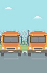 Image showing Yellow buses on the background of mesh fence.