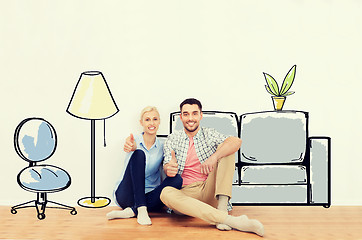 Image showing happy couple showing thumbs up at new home