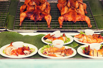 Image showing grilled or fried chicken on plate at street market