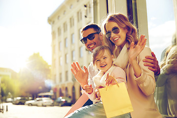 Image showing happy family with child and shopping bags in city