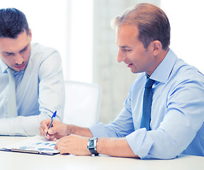 Image showing businessmen with notebook on meeting