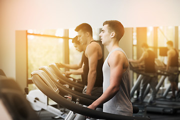 Image showing group of men exercising on treadmill in gym