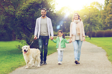 Image showing happy family with labrador retriever dog in park