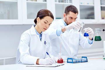 Image showing young scientists making test or research in lab