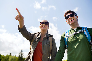 Image showing happy couple with backpacks hiking outdoors