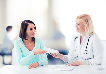 Image showing doctor giving prescription to patient in hospital