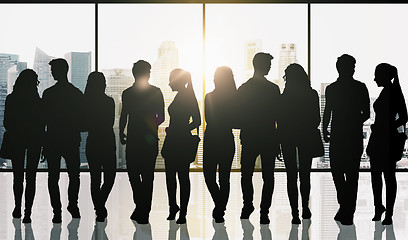 Image showing people silhouettes over window and city background