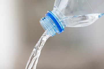 Image showing close up of water pouring from plastic bottle