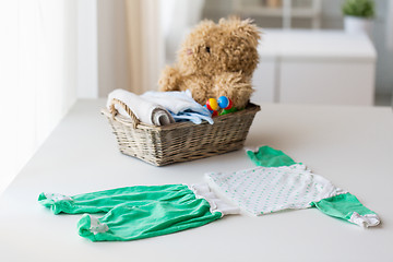 Image showing close up of baby clothes set and toys for newborn