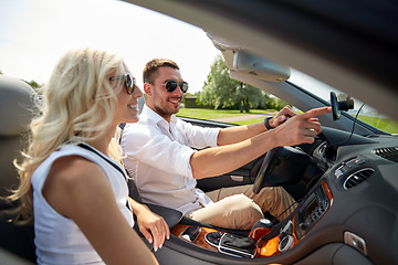 Image showing happy couple using gps navigation system in car