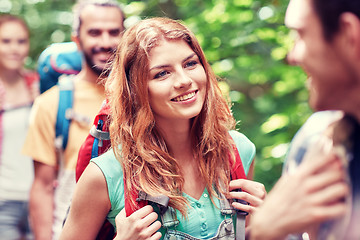 Image showing group of smiling friends with backpacks hiking