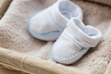 Image showing close up of baby bootees for newborn boy in basket