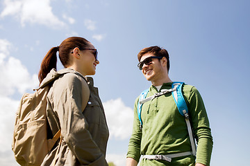 Image showing happy couple with backpacks hiking outdoors