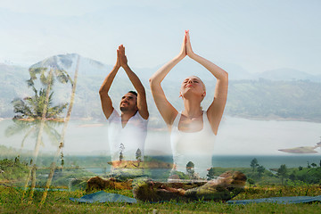 Image showing smiling couple making yoga exercises outdoors