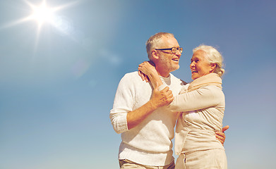 Image showing happy senior couple hugging outdoors