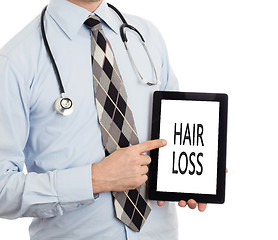 Image showing Doctor holding tablet - Hair loss