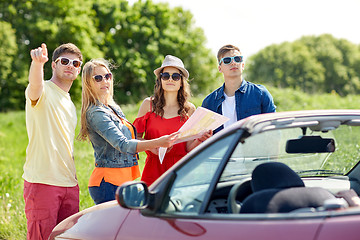 Image showing happy friends driving in cabriolet car