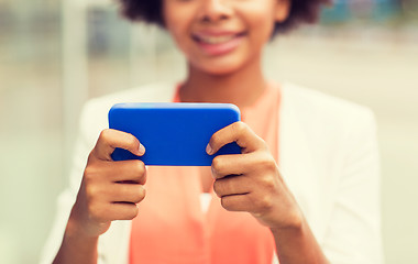 Image showing close up of african woman with smartphone in city