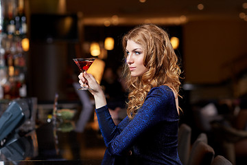 Image showing glamorous woman with cocktail at night club or bar