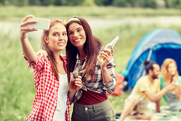 Image showing happy women taking selfie by smartphone at camping