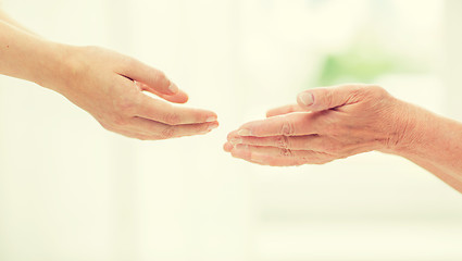 Image showing close up of senior and young woman hands