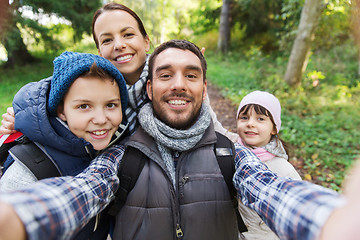 Image showing family with backpacks taking selfie and hiking