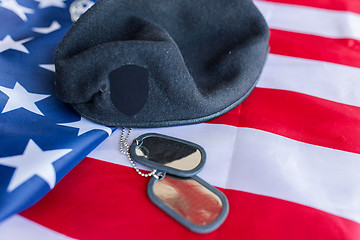 Image showing close up of american flag, hat and military badge