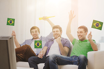 Image showing happy male friends with flags and vuvuzela