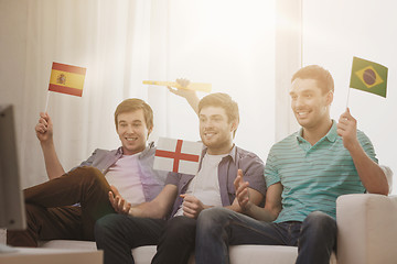 Image showing happy male friends with flags and vuvuzela