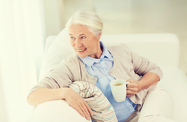 Image showing happy senior woman with cup of tea at home