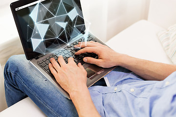 Image showing close up of man typing on laptop computer at home