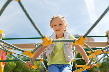 Image showing happy little girl climbing on children playground