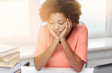 Image showing bored african american woman doing homework home