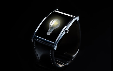 Image showing close up of smart watch with light bulb icon