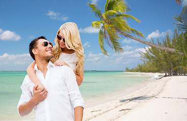 Image showing happy couple in sunglasses over summer beach