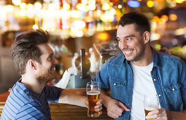 Image showing happy male friends drinking beer at bar or pub