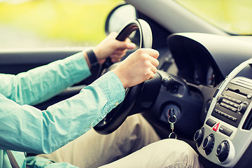 Image showing close up of young man driving car