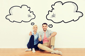 Image showing happy couple showing thumbs up at new home