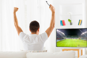 Image showing happy man watching football or soccer game on tv