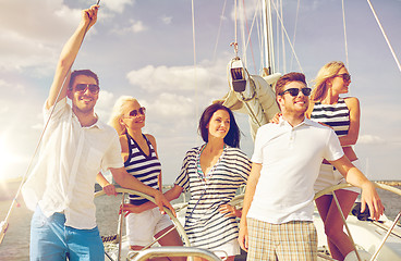 Image showing smiling friends sailing on yacht