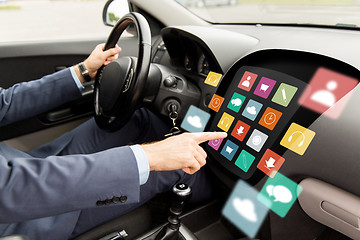 Image showing man driving car with menu icons on board computer