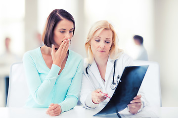 Image showing doctor with patient looking at x-ray