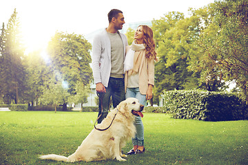 Image showing happy couple with labrador dog walking in city